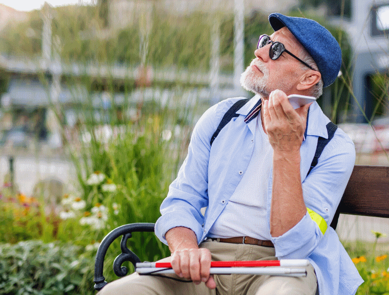 Photograph of a Man on a bench with a phone