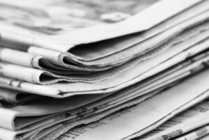 A Photograph of a stack of Newspapers depicting titles available on RNIB newsagent